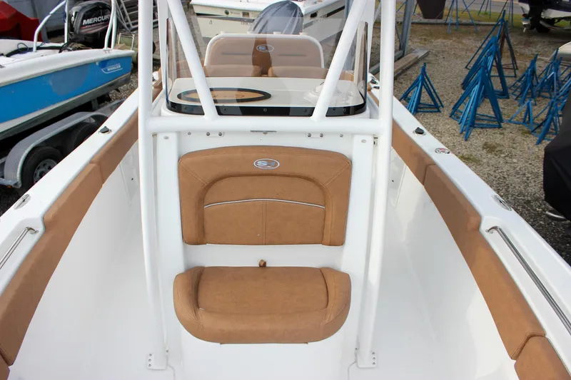 Slide: The Image of 2026 Sea Hunt Ultra 219 boat interior with tan seating and white console. - 39