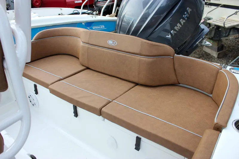 Slide: The Image of 2026 Sea Hunt Ultra 219 boat with brown cushioned seating and Yamaha engine. - 4