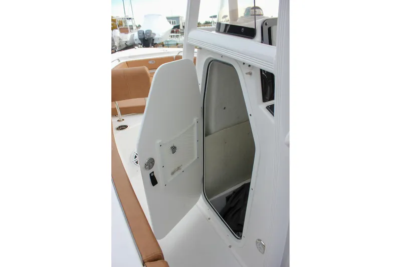 Slide: The Image of 2026 Sea Hunt Ultra 219 boat interior with open storage compartment door. - 43
