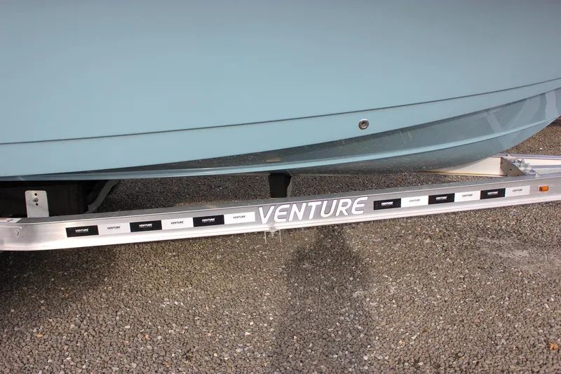 Slide: The Image of 2026 Sea Hunt Ultra 219 boat on Venture trailer, parked on gravel. - 46