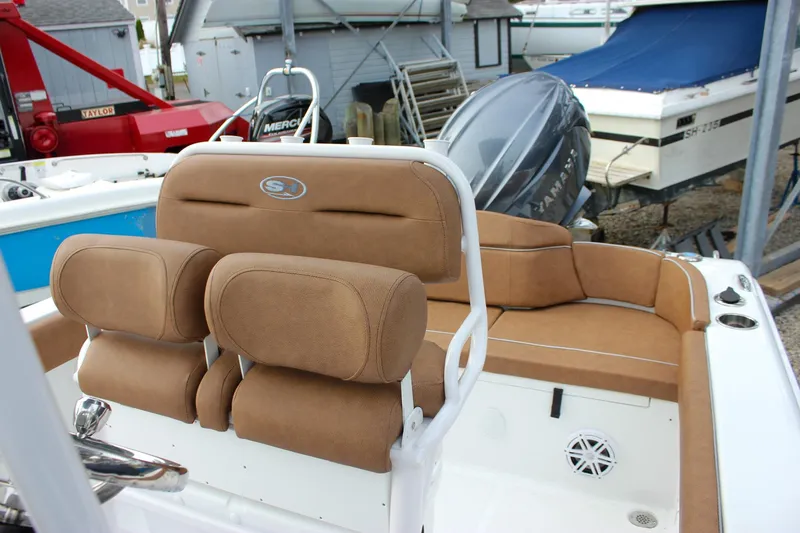 Slide: The Image of 2026 Sea Hunt Ultra 219 boat interior with tan seating and Yamaha engine. - 5