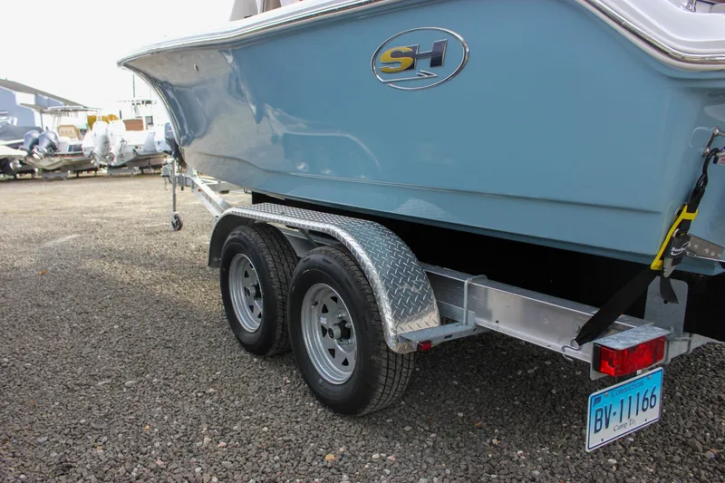 Slide: The Image of 2026 Sea Hunt Ultra 219 boat on trailer, featuring dual wheels and Connecticut license plate. - 50