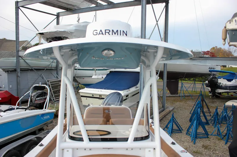 Slide: The Image of 2026 Sea Hunt Ultra 219 boat with Garmin equipment in a marina storage area. - 7