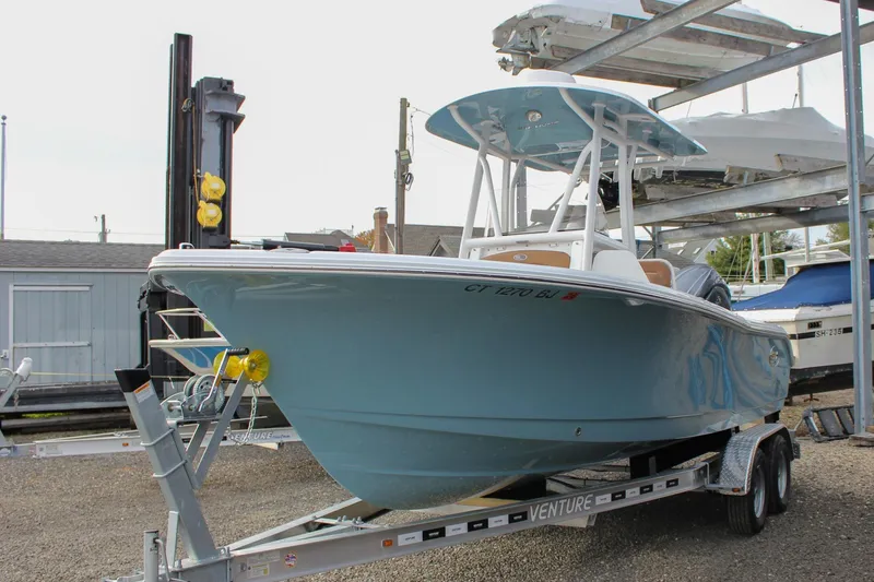 Slide: The Image of 2026 Sea Hunt Ultra 219 boat on trailer in marina setting. - 9