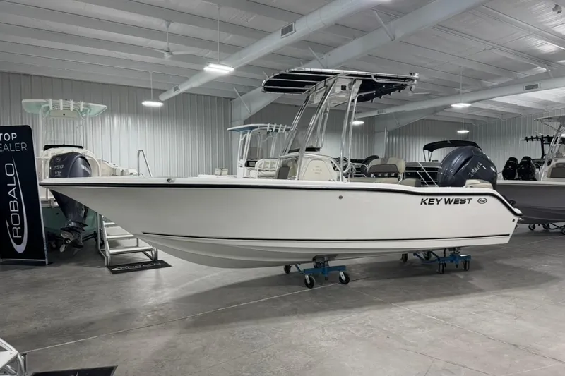 The Image of 2026 Key West 203 FS boat displayed in a showroom with other boats. - 1