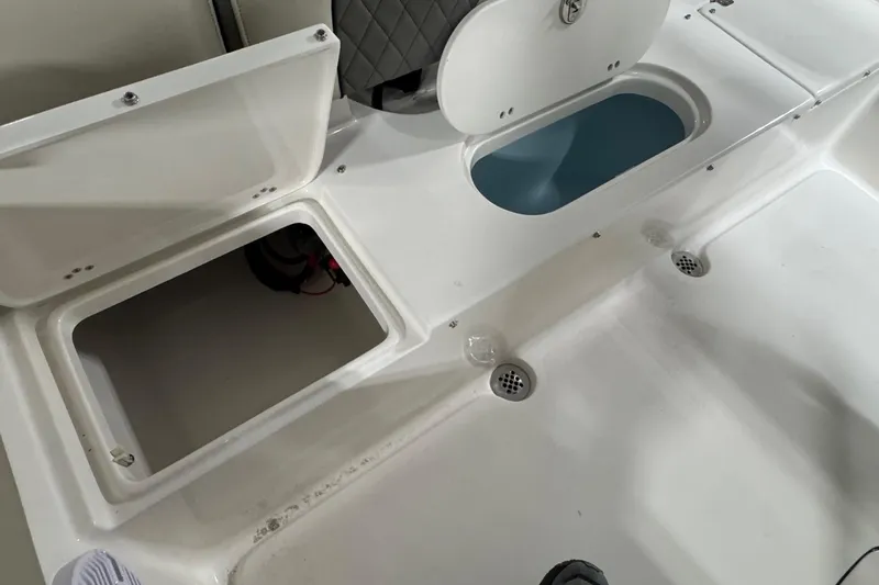 Slide: The Image of Key West 203 FS 2026 boat storage compartments and seating area. - 16