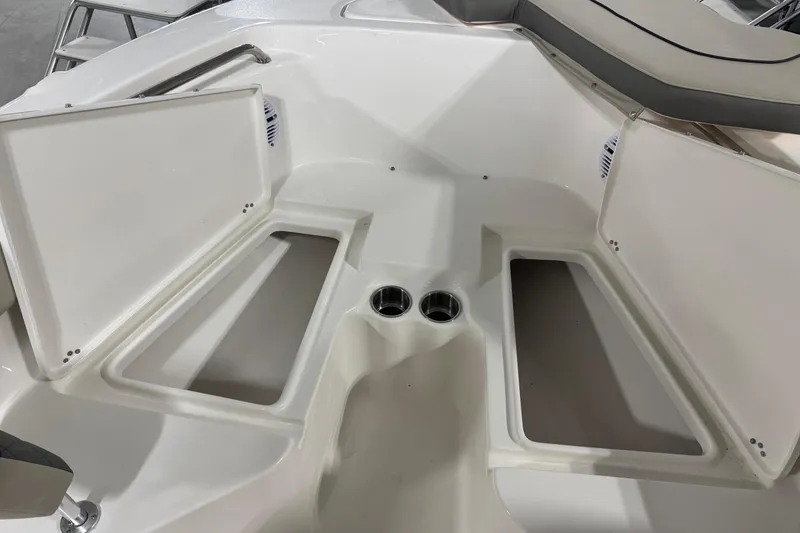 Slide: The Image of 2026 Key West 203 FS boat interior with open storage compartments and cup holders. - 5