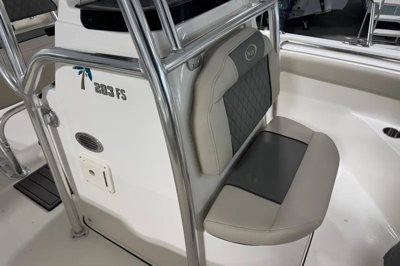 Slide: The Image of 2026 Key West 203 FS boat interior with cushioned seating and stainless steel railings. - 8