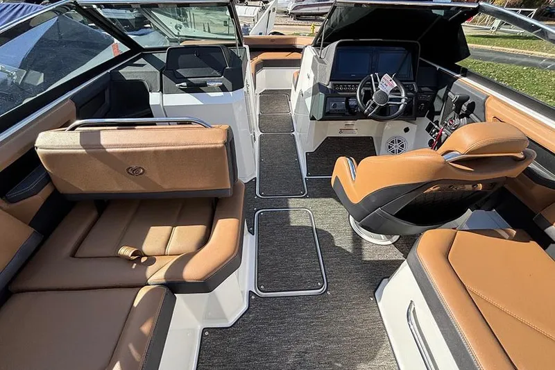 Slide: The Image of 2021 Cobalt R6 boat interior with brown seating and modern dashboard. - 11