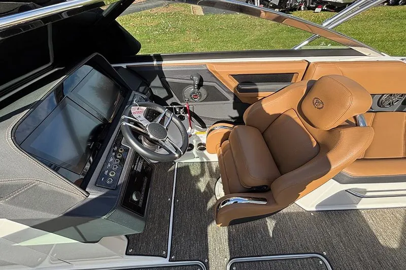 Slide: The Image of 2021 Cobalt R6 boat interior with brown leather seat and modern dashboard. - 14