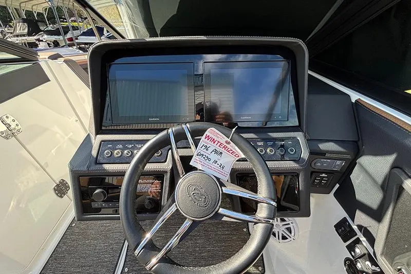 Slide: The Image of 2021 Cobalt R6 boat dashboard with dual Garmin displays and steering wheel. - 15