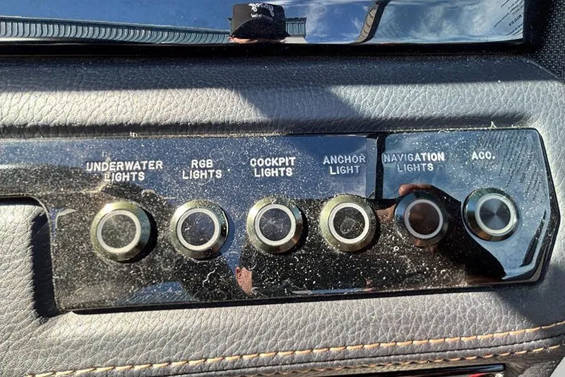 Slide: The Image of Control panel of a 2021 Cobalt R6 boat with various light switches. - 17