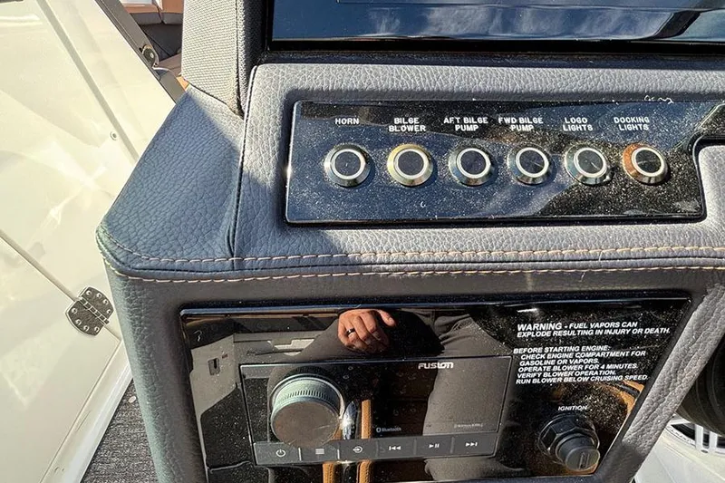 Slide: The Image of Control panel of a 2021 Cobalt R6 boat with various switches and warning label. - 18