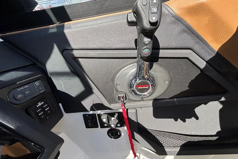 Slide: The Image of 2021 Cobalt R6 boat throttle control panel with trim and power buttons. - 19