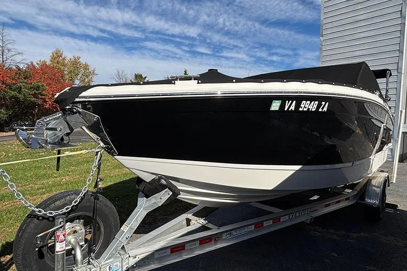 Slide: The Image of 2021 Cobalt R6 boat on trailer, black and white design, parked outdoors. - 3