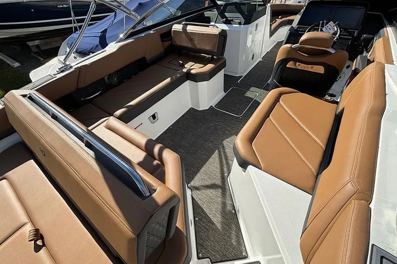 Slide: The Image of 2021 Cobalt R6 boat interior with luxurious brown seating and modern design. - 8