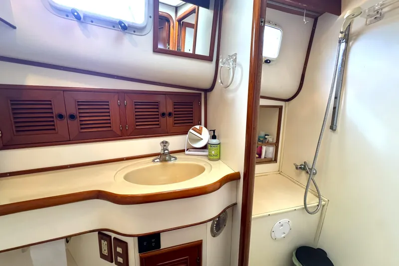 Slide: The Image of Bathroom interior of 1988 Offshore Yachts 48 Sedan with sink and shower. - 12