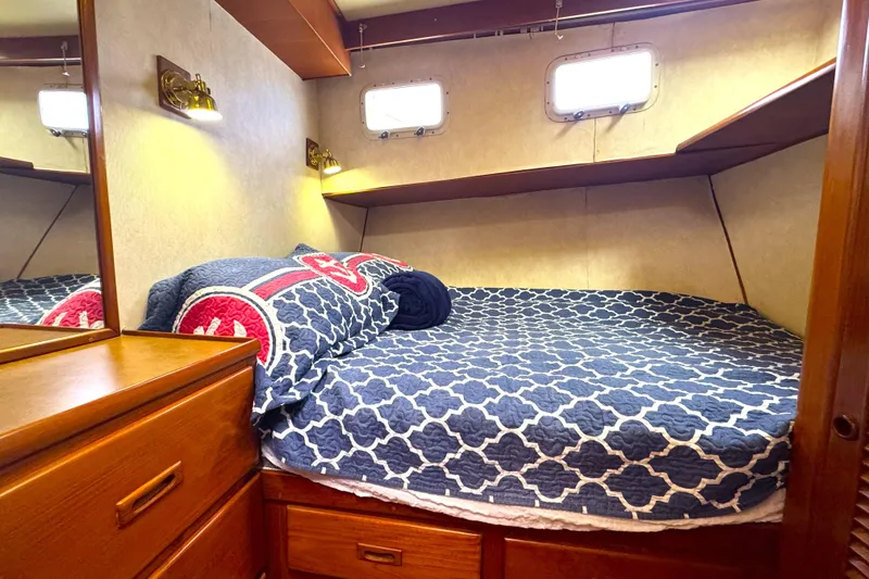 Slide: The Image of Cozy cabin interior of 1988 Offshore Yachts 48 Sedan with nautical bedding. - 13