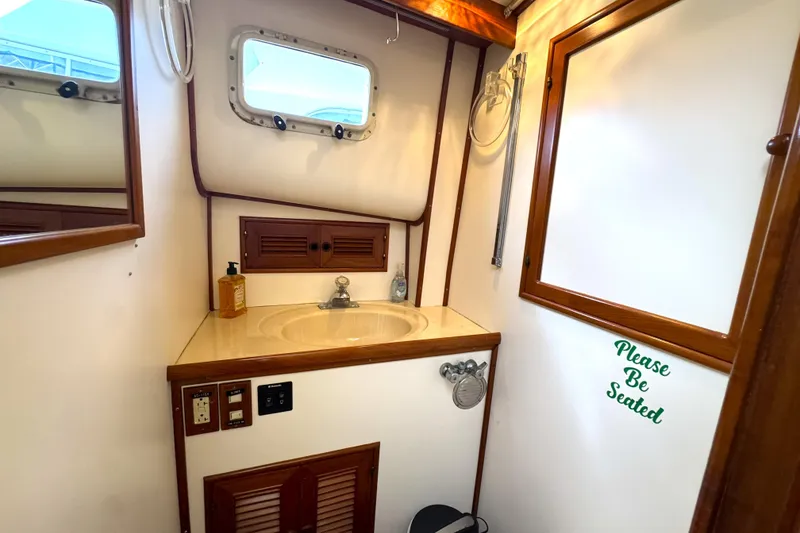 Slide: The Image of Bathroom interior of 1988 Offshore Yachts 48 Sedan with sink and nautical decor. - 14