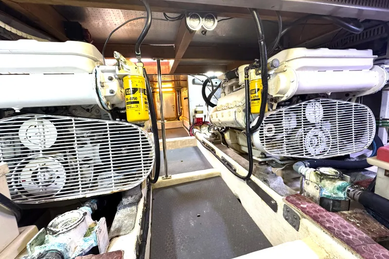 Slide: The Image of Engine room of 1988 Offshore Yachts 48 Sedan, featuring dual engines and safety equipment. - 19