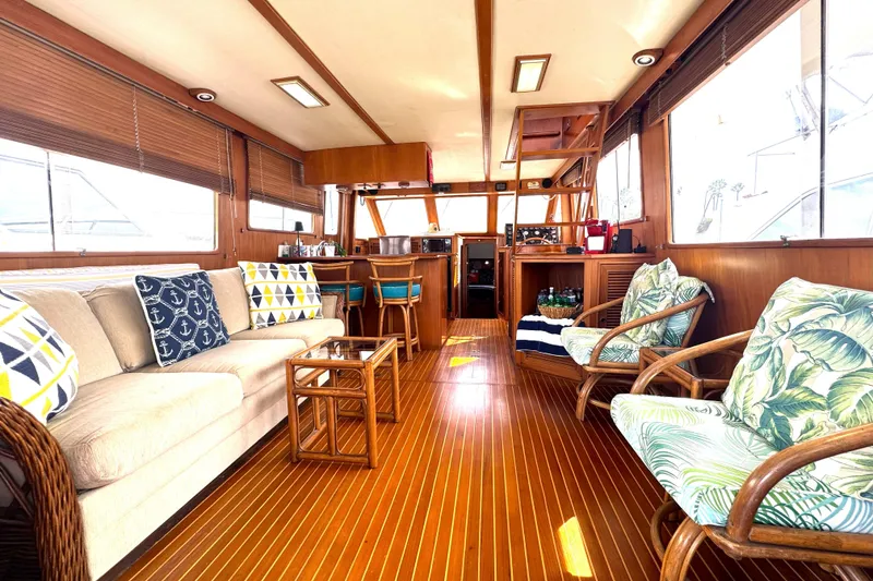 Slide: The Image of Interior of 1988 Offshore Yachts 48 Sedan with cozy seating and wooden flooring. - 3