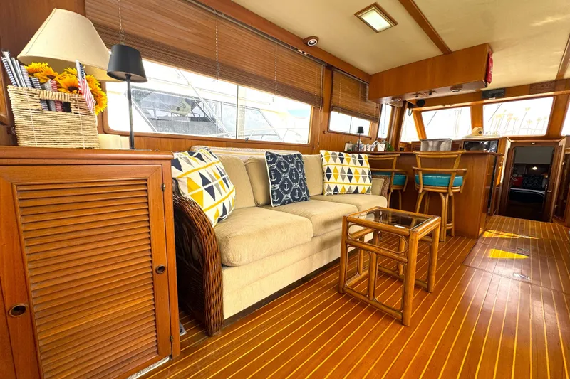 Slide: The Image of Interior of 1988 Offshore Yachts 48 Sedan with cozy seating and wooden decor. - 4