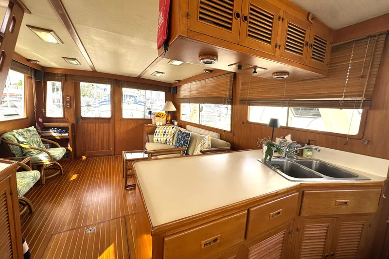 Slide: The Image of Interior of 1988 Offshore Yachts 48 Sedan with wood finish and cozy seating area. - 5