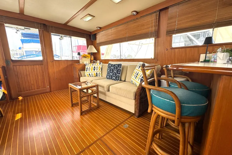 Slide: The Image of Luxurious interior of 1988 Offshore Yachts 48 Sedan with wooden flooring and cozy seating. - 6