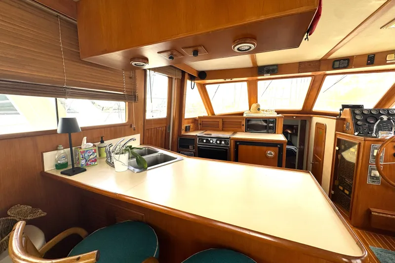 Slide: The Image of Interior of 1988 Offshore Yachts 48 Sedan with kitchen and helm station. - 7