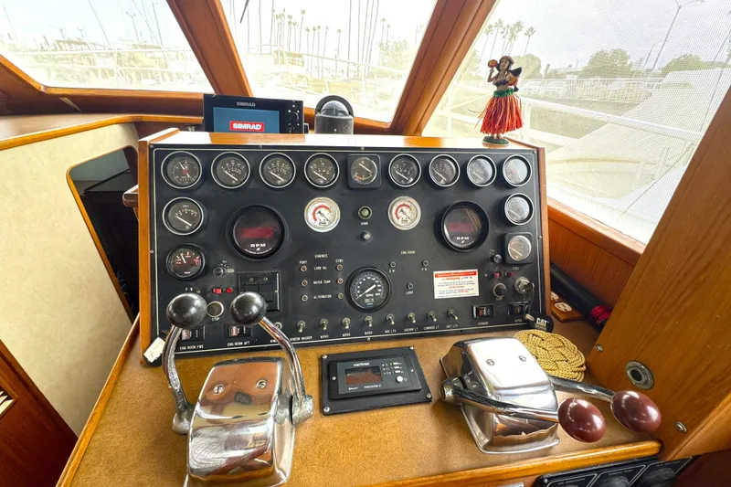 Slide: The Image of Control panel of a 1988 Offshore Yachts 48 Sedan with gauges and levers. - 9