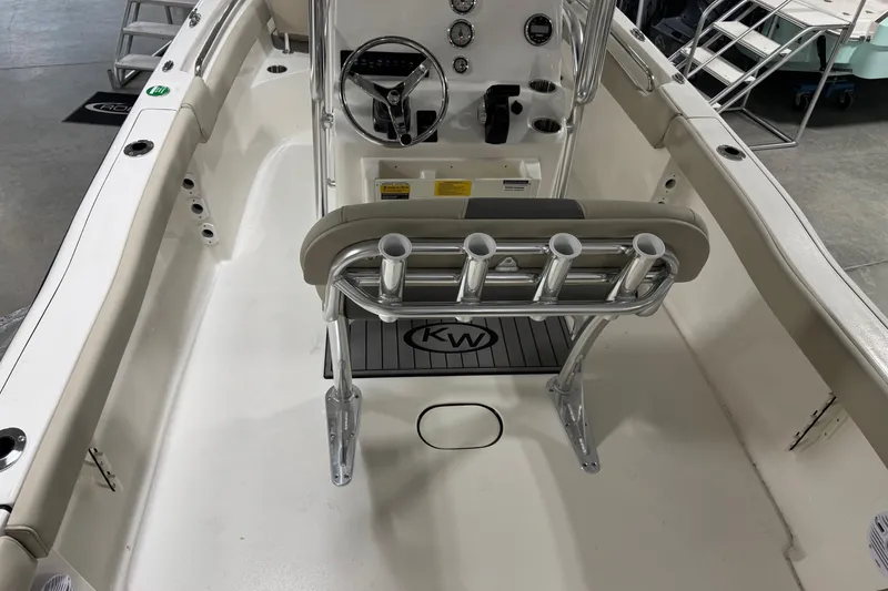 Slide: The Image of 2026 Key West 203 FS boat interior with steering console and rod holders. - 17