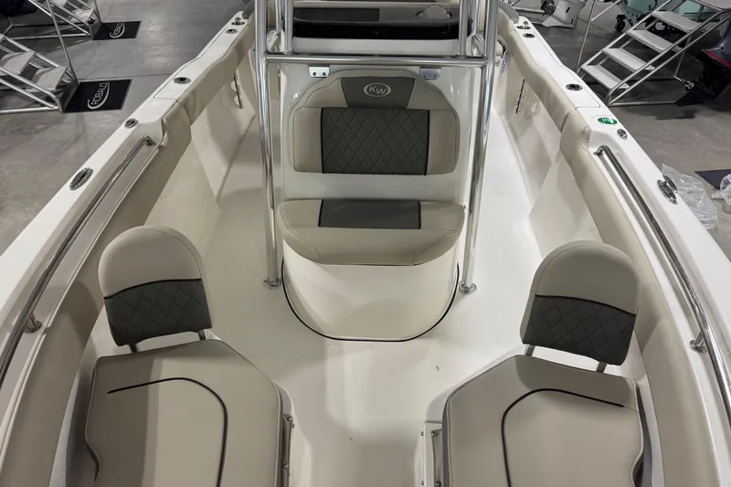 Slide: The Image of 2026 Key West 203 FS boat interior with cushioned seating and stainless steel railings. - 7