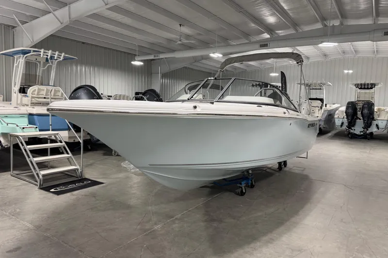 The Image of 2026 Key West 203 DFS boat displayed in a showroom with other boats. - 1