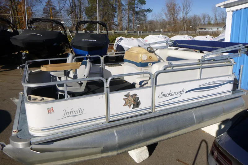 The Image of 2003 Smoker Craft 816 Infinity Fish pontoon boat in storage yard. - 0
