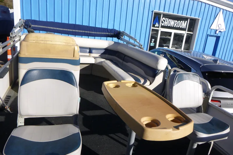 Slide: The Image of 2003 Smoker Craft 816 Infinity Fish boat interior with seating and table, outside showroom. - 10