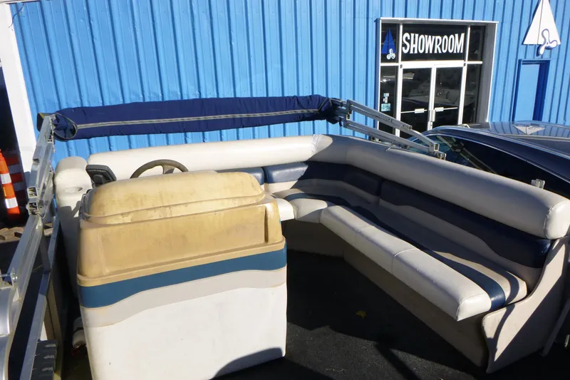 Slide: The Image of 2003 Smoker Craft 816 Infinity Fish boat interior with blue and white seating near showroom. - 11
