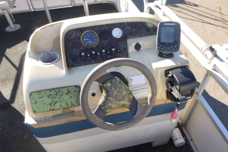 Slide: The Image of 2003 Smoker Craft 816 Infinity Fish boat dashboard with steering wheel and navigation equipment. - 14