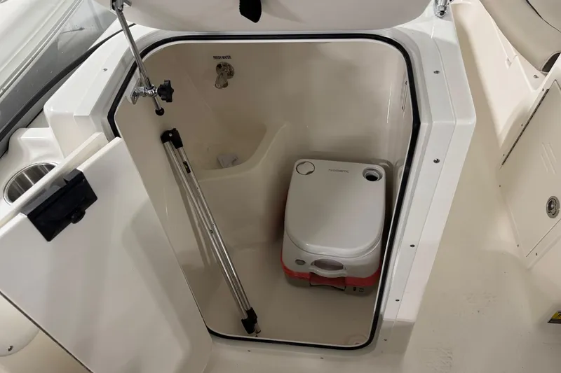 Slide: The Image of 2026 Key West 203 DFS boat interior with portable toilet and fresh water access. - 15