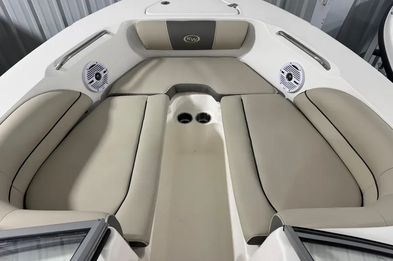 Slide: The Image of 2026 Key West 203 DFS boat interior with beige seating and built-in speakers. - 6