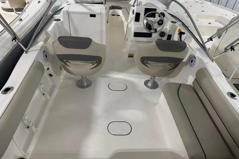 Slide: The Image of 2026 Key West 203 DFS boat interior with seating and steering console. - 16
