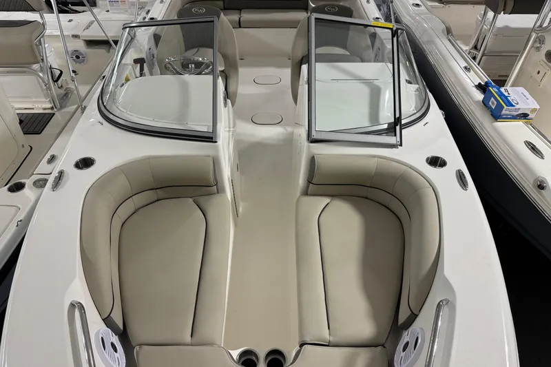 Slide: The Image of 2026 Key West 203 DFS boat interior with beige seating and open windshield. - 4