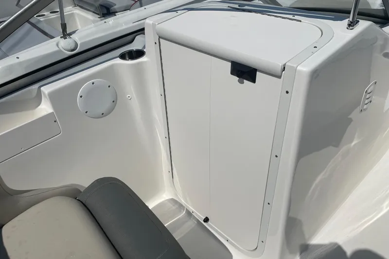 Slide: The Image of 2026 Key West 203 DFS boat interior, featuring a sleek white console and seating area. - 15