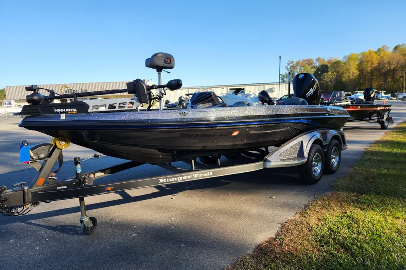 Slide: The Image of 2020 Ranger Z519 boat on trailer, equipped with Minn Kota motor, parked outdoors. - 7