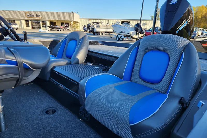 Slide: The Image of 2020 Ranger Z519 boat interior with blue and gray seats at a dealership. - 9