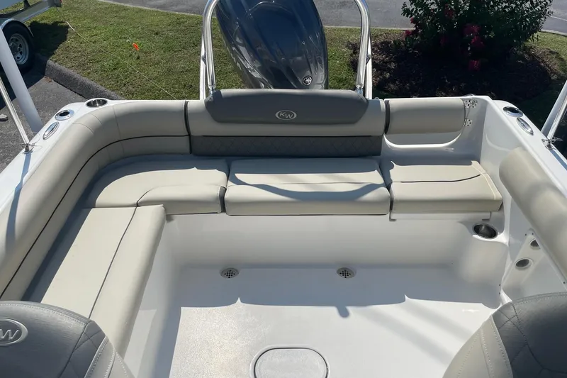 Slide: The Image of 2026 Key West 203 DFS boat interior with cushioned seating and cup holders. - 18