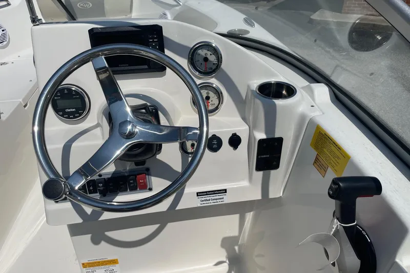 Slide: The Image of Steering console of 2026 Key West 203 DFS boat with gauges and controls. - 14