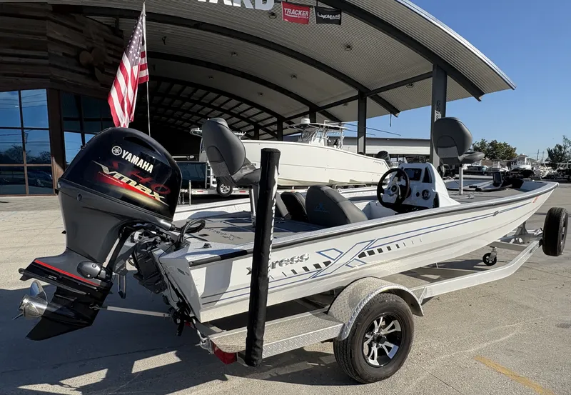 Slide: The Image of 2022 Xpress H18 boat with Yamaha engine on trailer, displayed outdoors. - 5