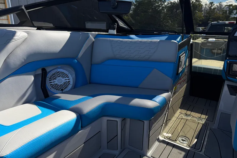 Slide: The Image of Interior of 2025 Centurion Ri230 boat with blue and gray seating. - 11