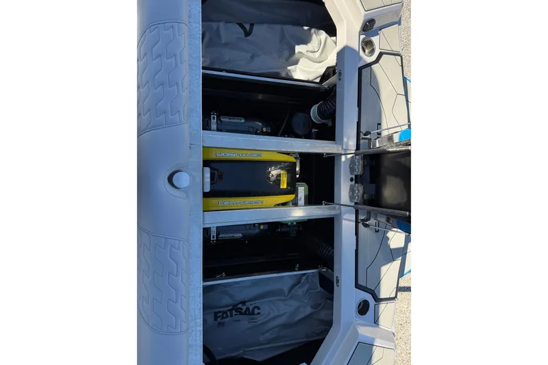 Slide: The Image of 2025 Centurion Ri230 boat interior showing storage compartments and equipment. - 13