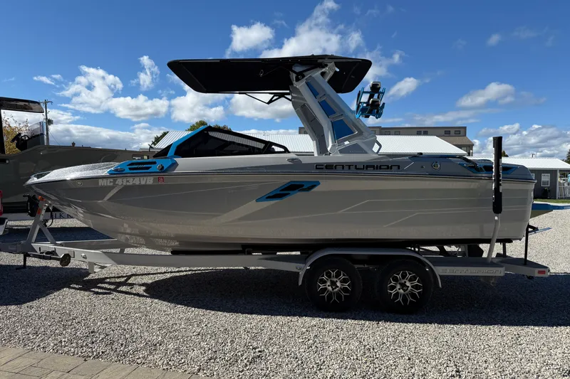 Slide: The Image of 2025 Centurion Ri230 boat on trailer under blue sky. - 4